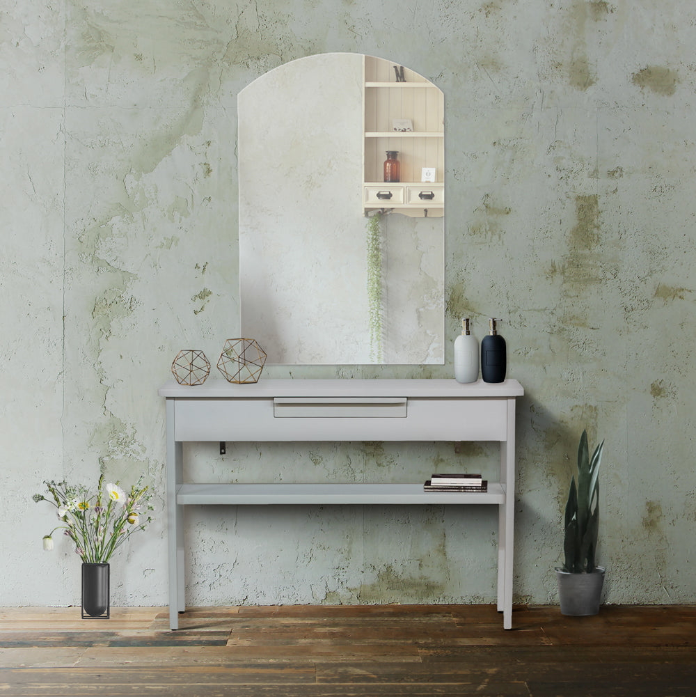 サロンにあるフレームレスアーチミラーとベージュコンソール